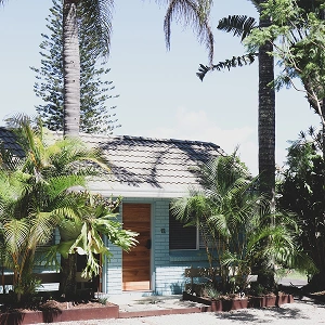 The Chalet Motel exterior surrounded by palm trees
